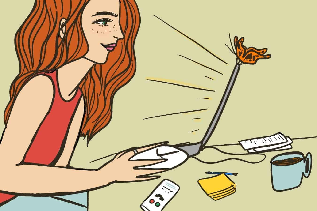 Redhead woman working in front of laptop with butterfly on top.