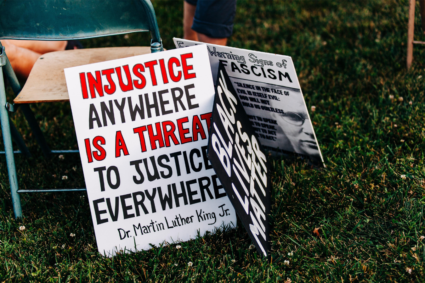 Sign with a quote from Martin Luther King Jr about injustice - how can leaders help their team through difficult social issues?