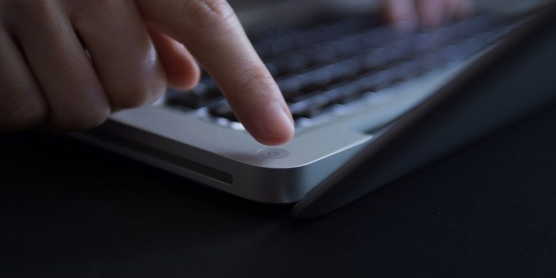 Turning off laptop computer.