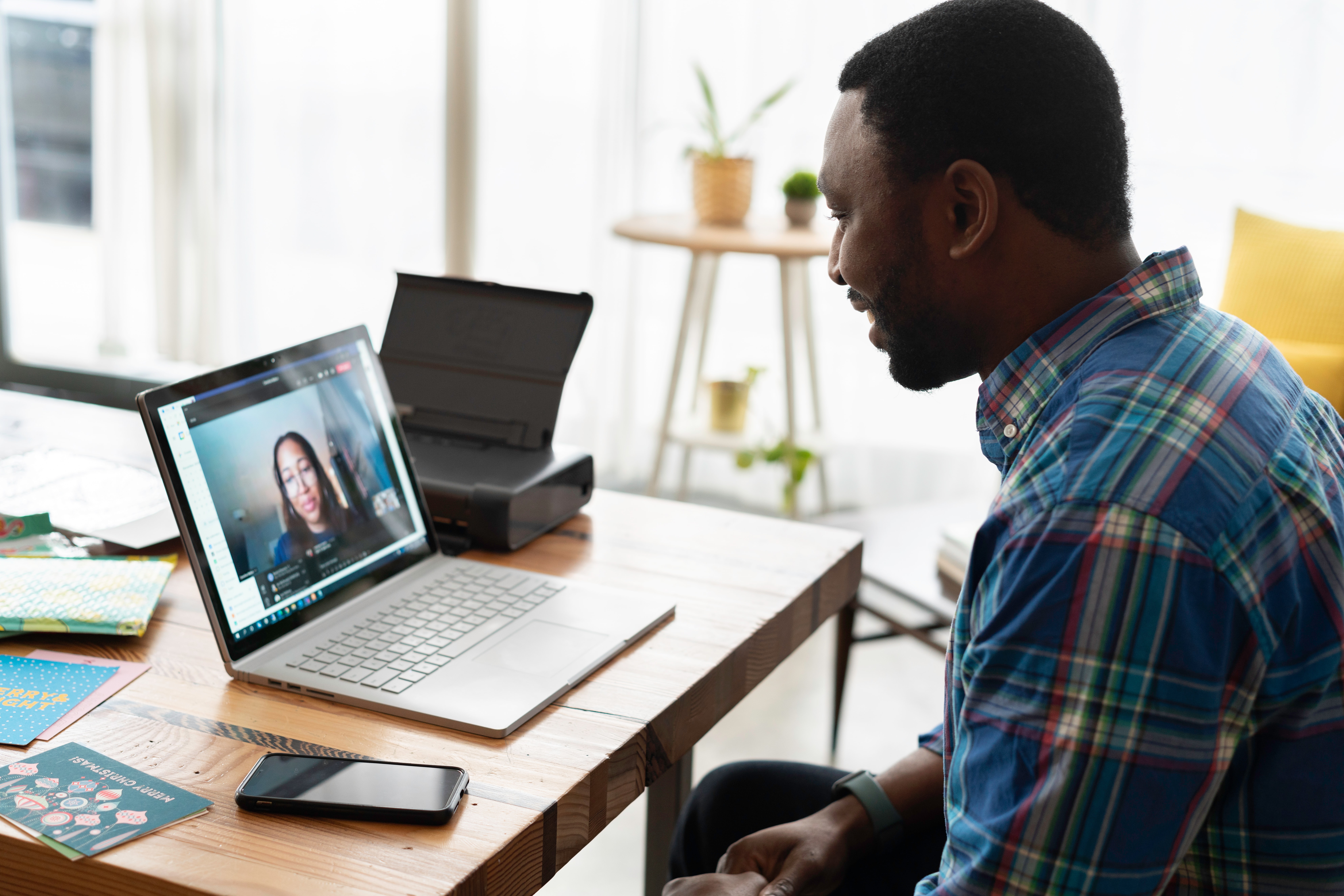 Man managing freelancers over video call.