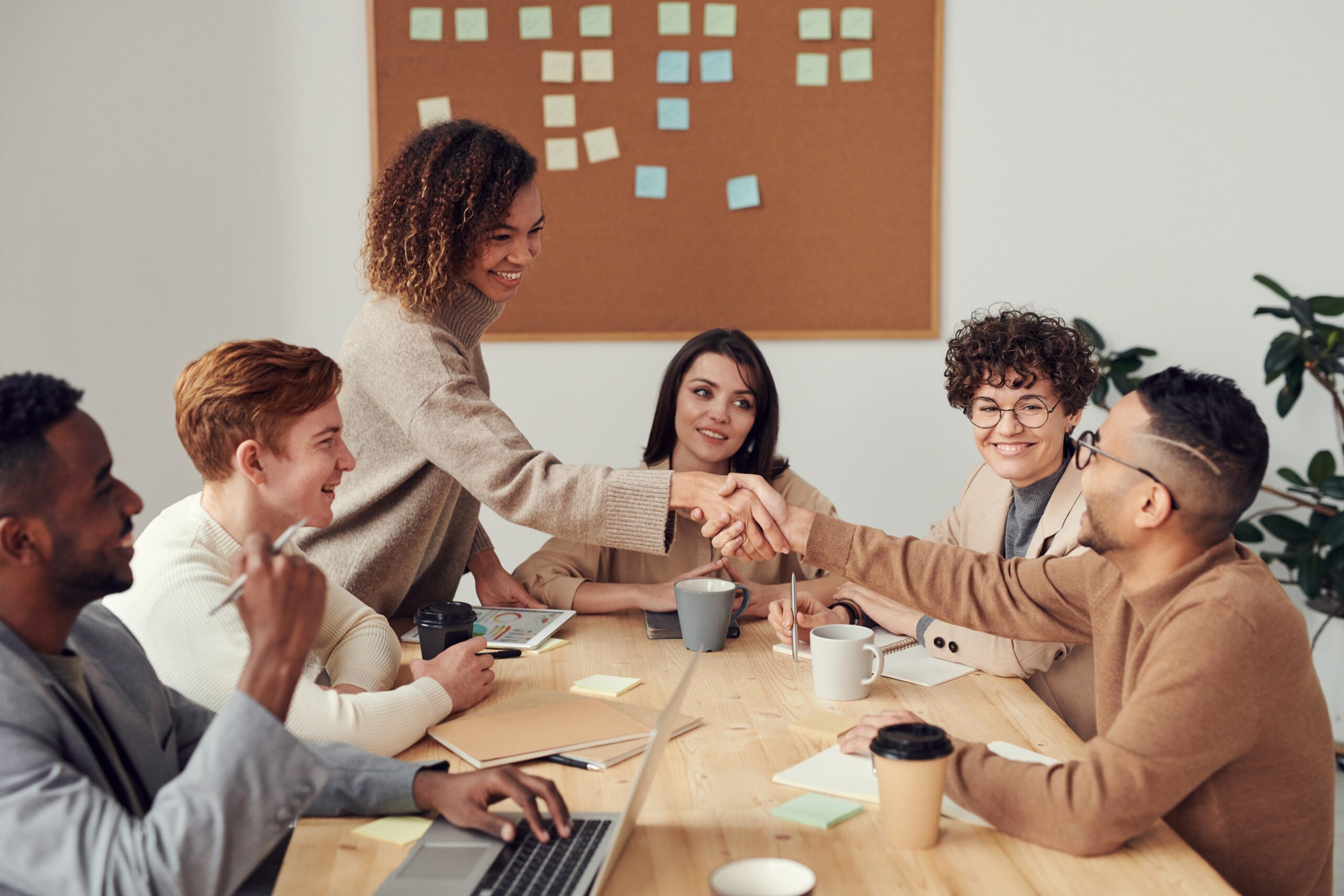 a diverse work team sitting around a conference table