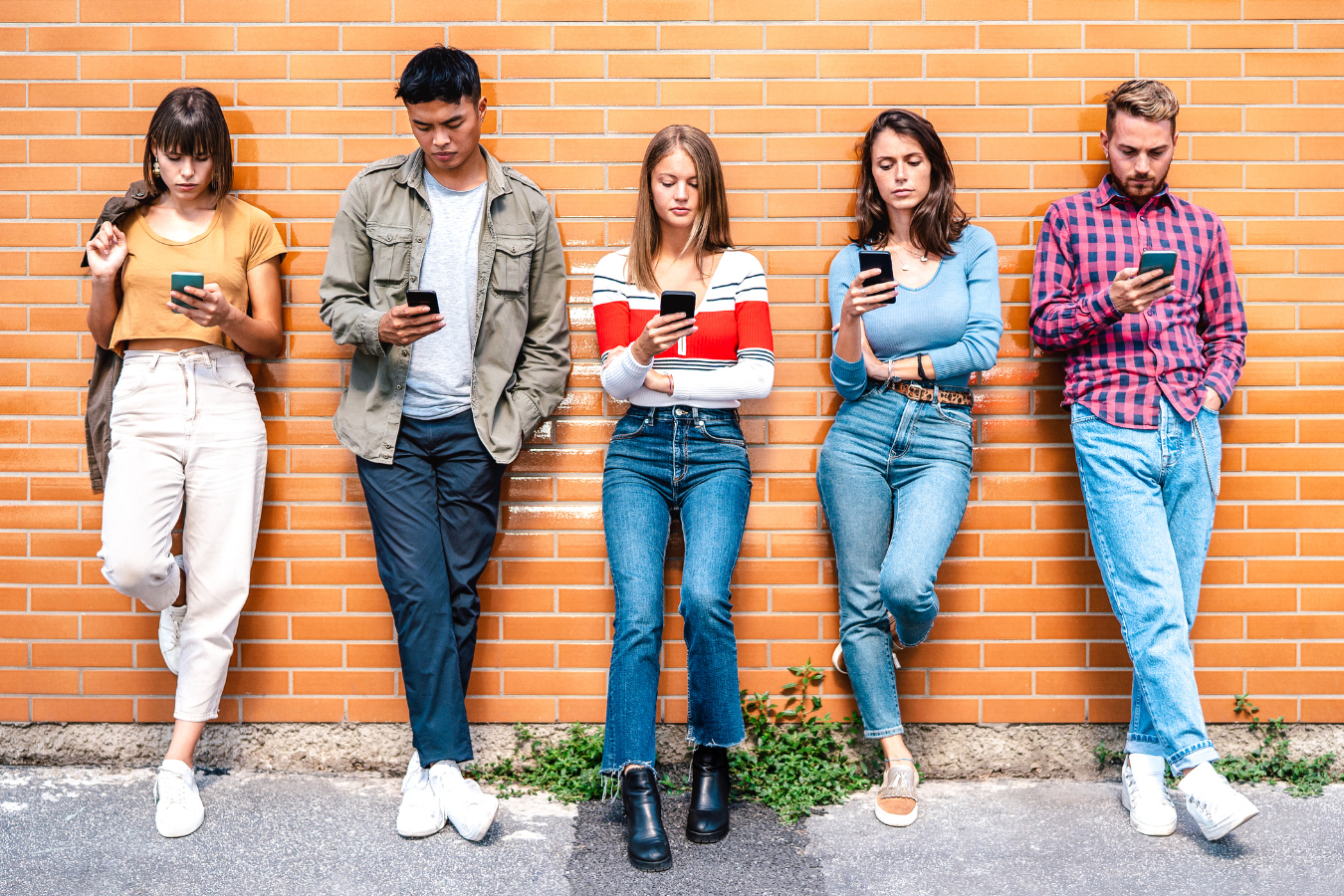 Members of Gen Z using mobile phones, a critical part of any Gen Z marketing plan
